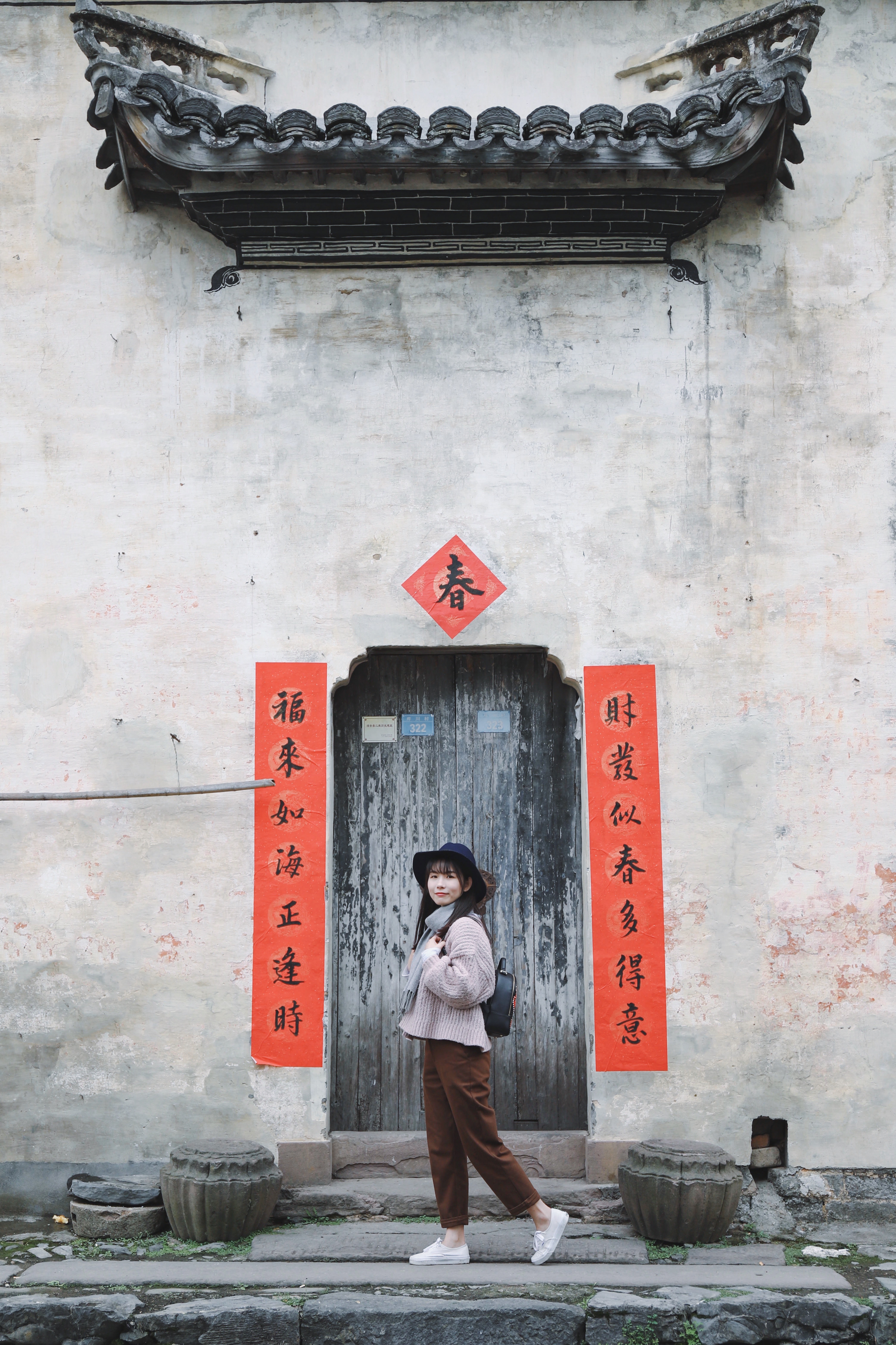 woman standing in front of a chinese doorway